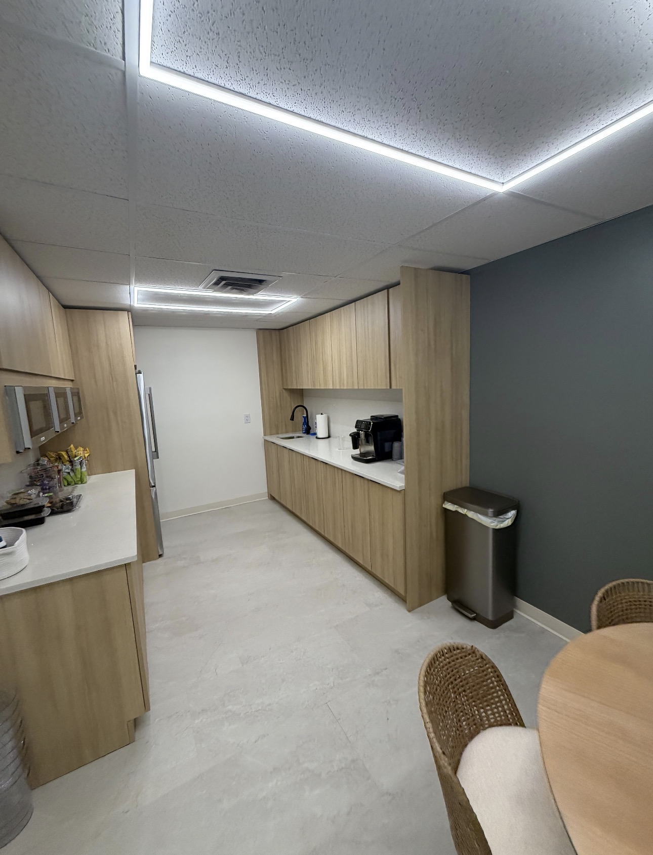 Commercial pantry kitchen with light wood cabinetry and quartz counters