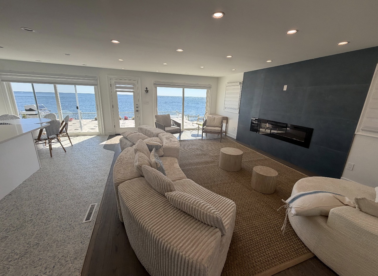 Finished living room with ocean views, fireplace and curved sectional