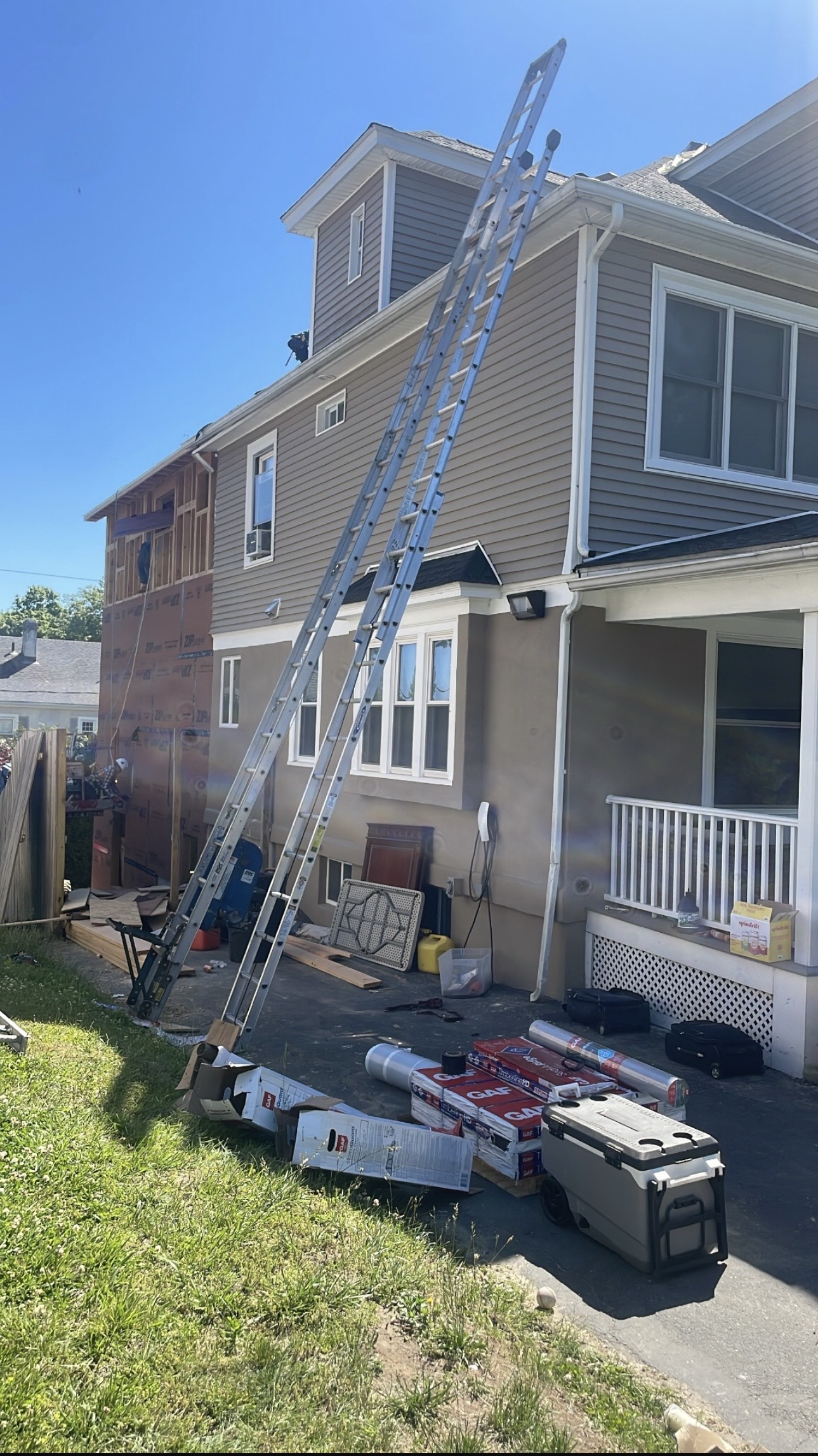 Roof shingles being laid on a house