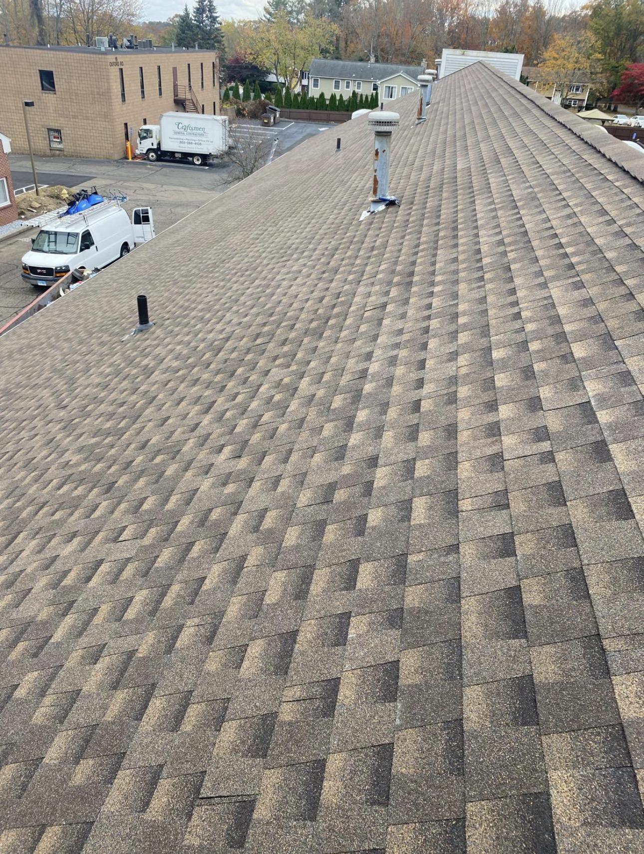 Completed architectural shingle roof looking down the ridge