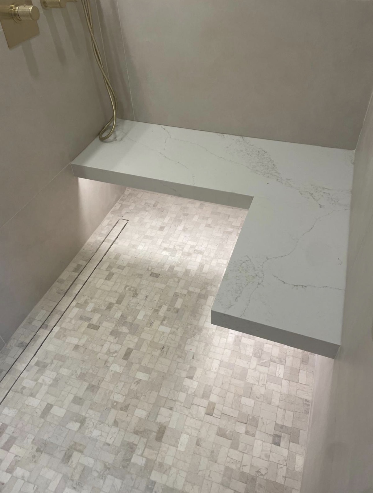 Marble shower bench and mosaic tile floor